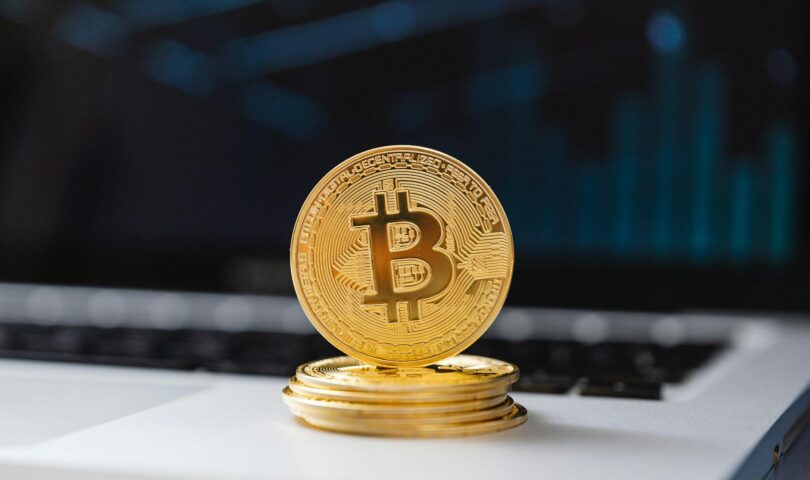 selective focus of bitcoins on laptop computer